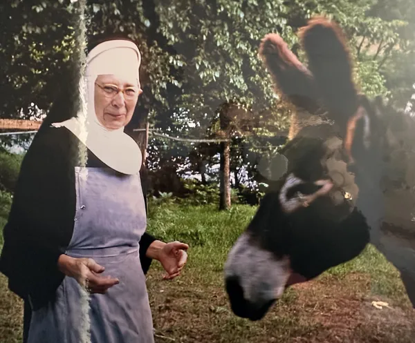 A sister greeting a visitor outdoors