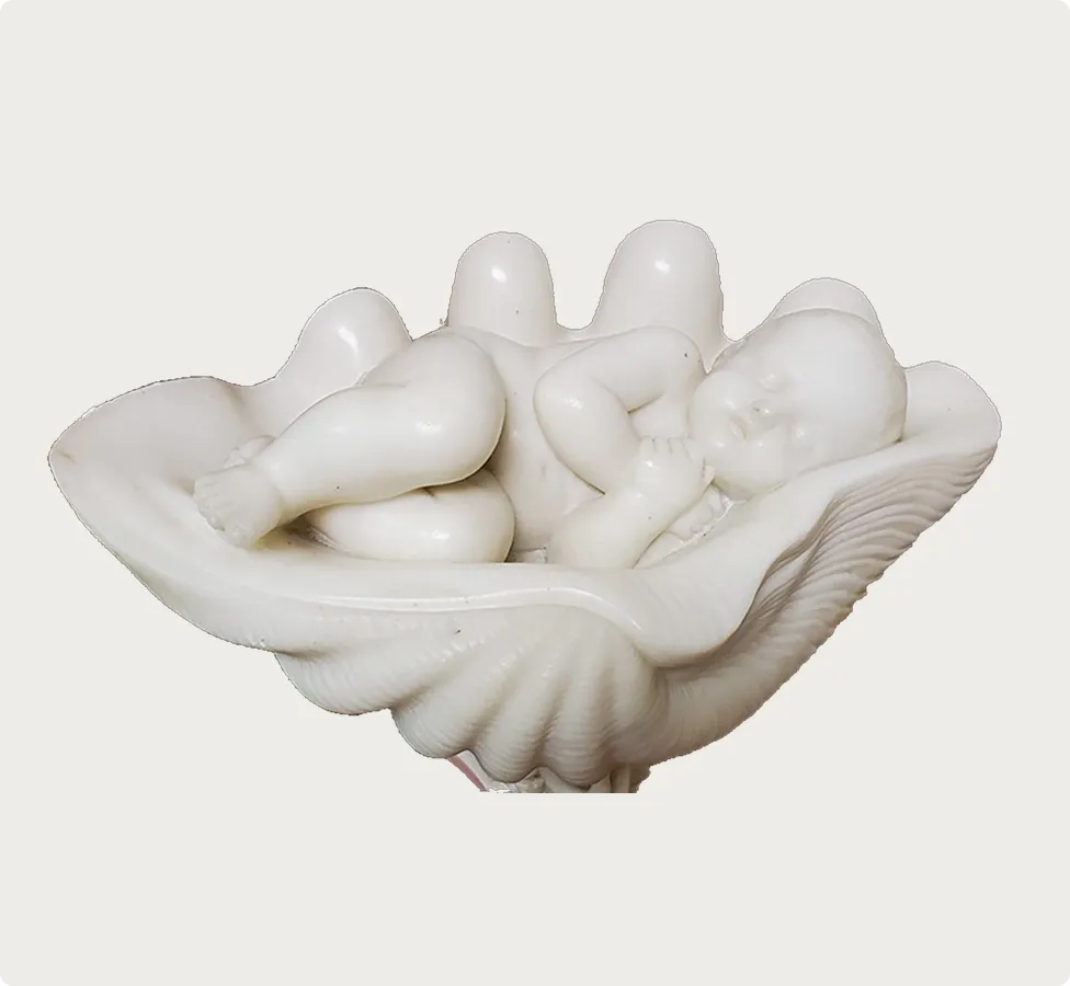 Sculpture of an infant cradled in a shell