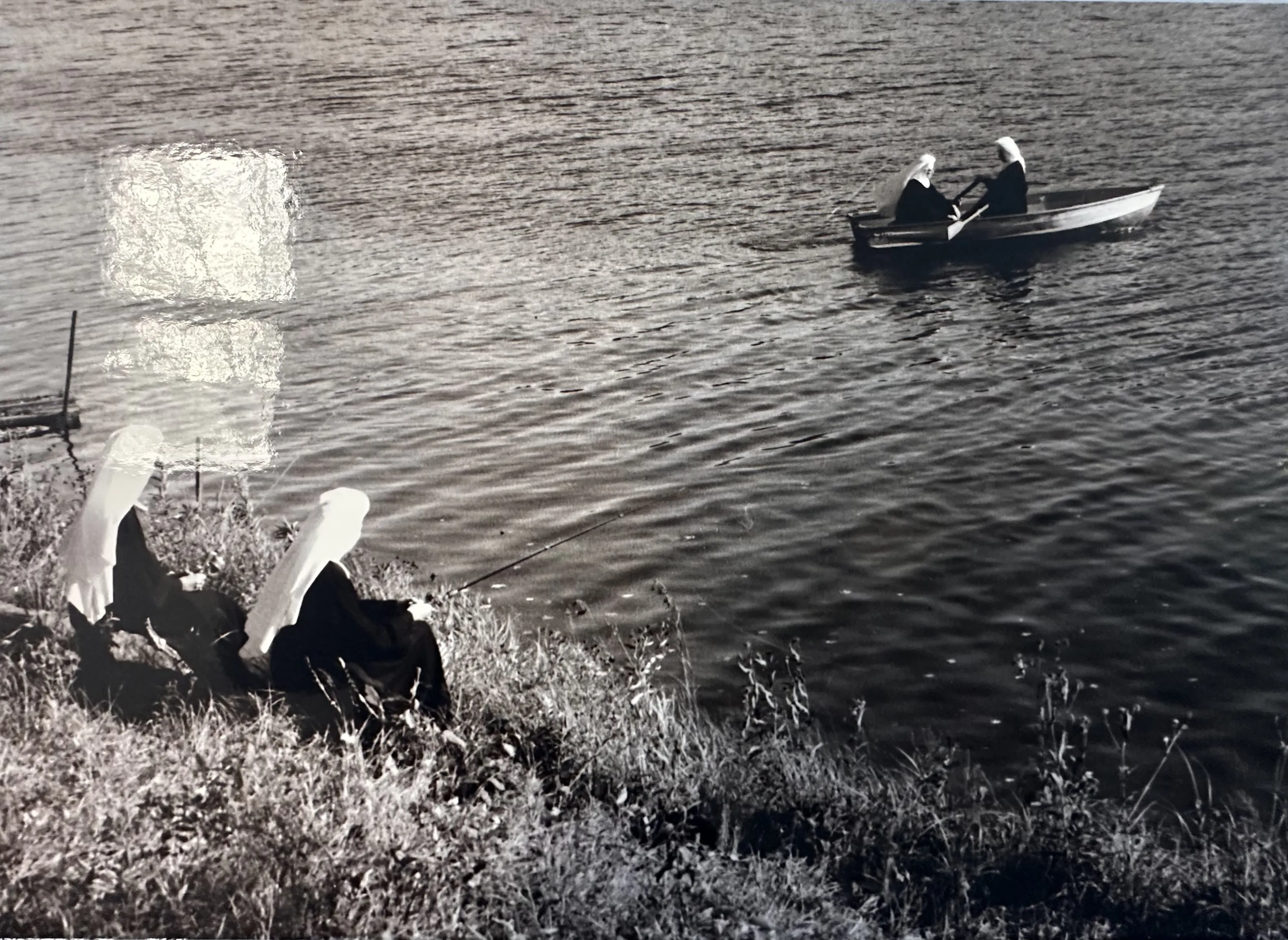 Archival photograph of two Sisters rowing a boat on a lake