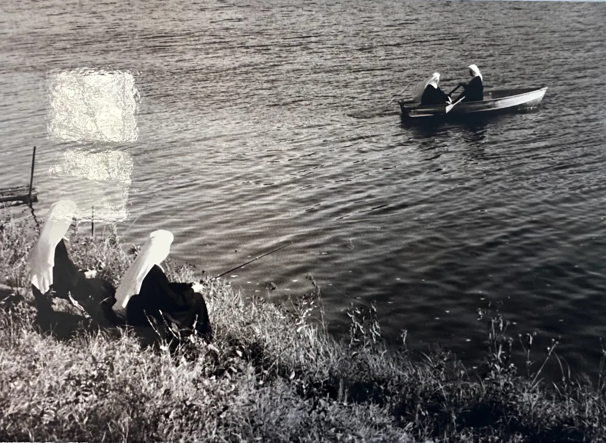 Archival photograph of two Sisters rowing a boat on a lake