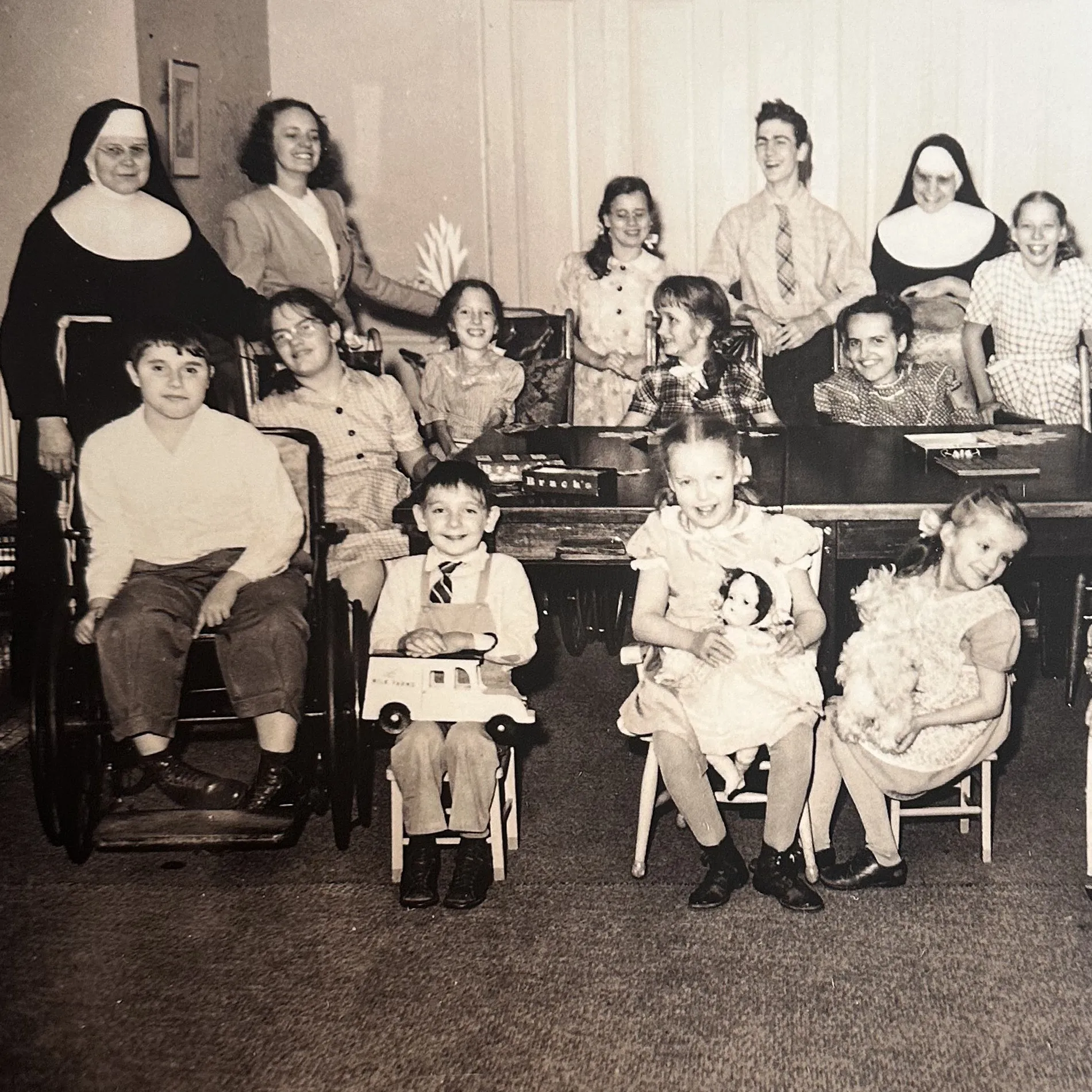 Archival photograph of a Sister seated with a group of children