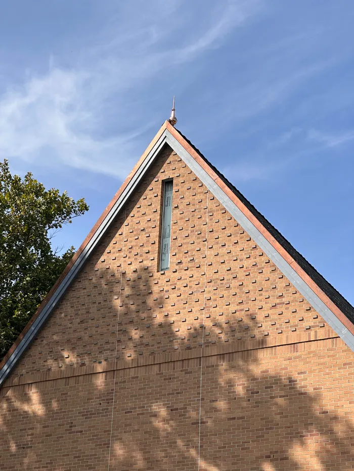 Exterior gable of the Heritage and Research Center building against a blue sky